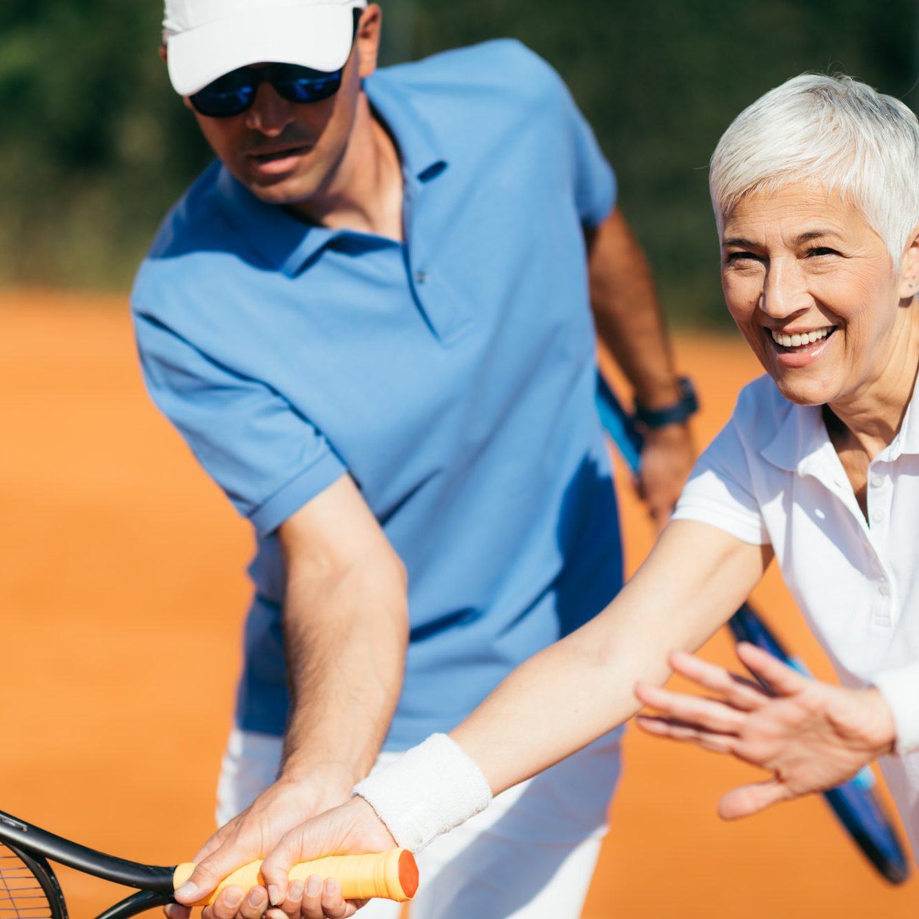 Active Senior Woman Practicing Tennis