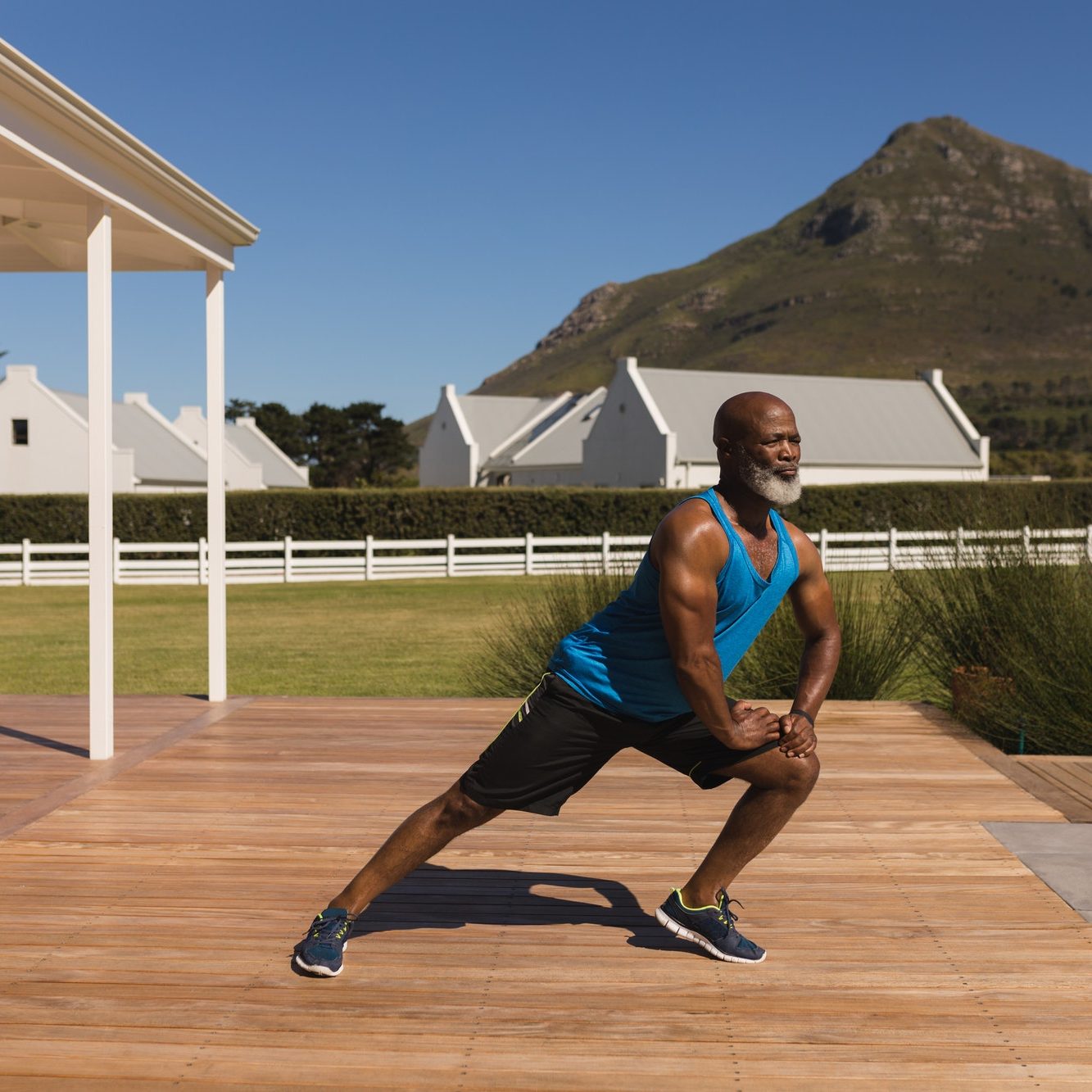 Active senior African American man performing stretching exercise