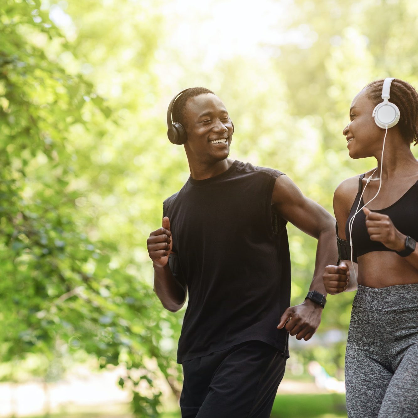 Couples Active Leisure. Happy Black Guy And Girl Jogging Together Outdoors