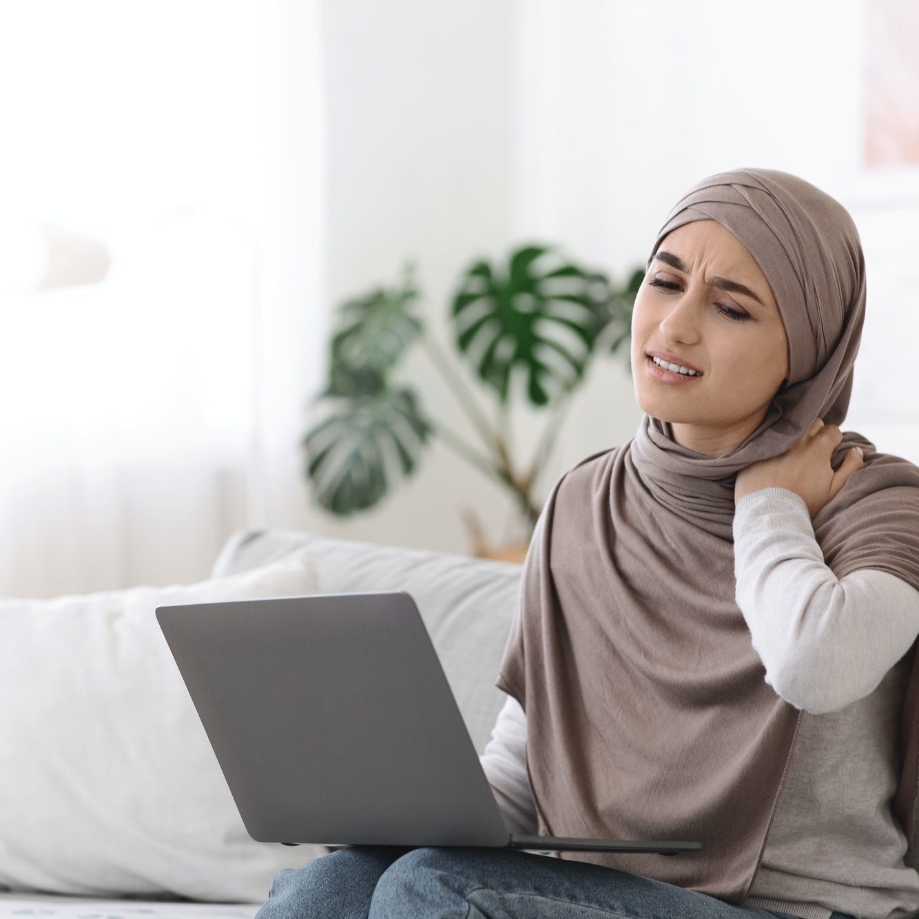 Neck Pain. Muslim Woman Massaging Inflamed Neck Tired Of Work At Laptop